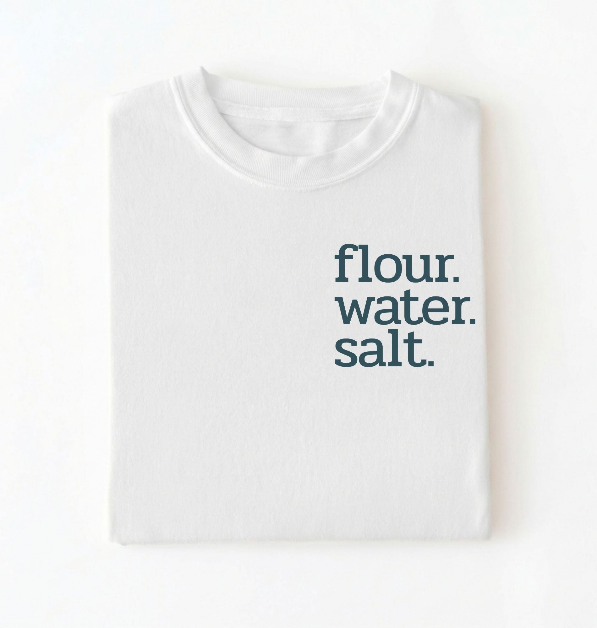 Flat lay of a white flour water salt shirt black minimalist sourdough baking t shirt bread lover gift simple design on a white background 