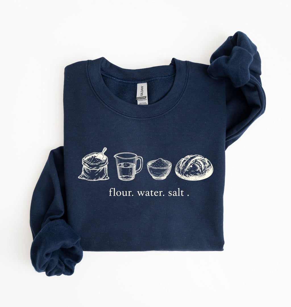 A navy sourdough sweatshirt featuring vintage illustrations of flour, water, salt and a freshly baked bread loaf on a white background