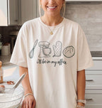 Person wearing a white t-shirt with kitchen-themed graphics and text in a kitchen setting
