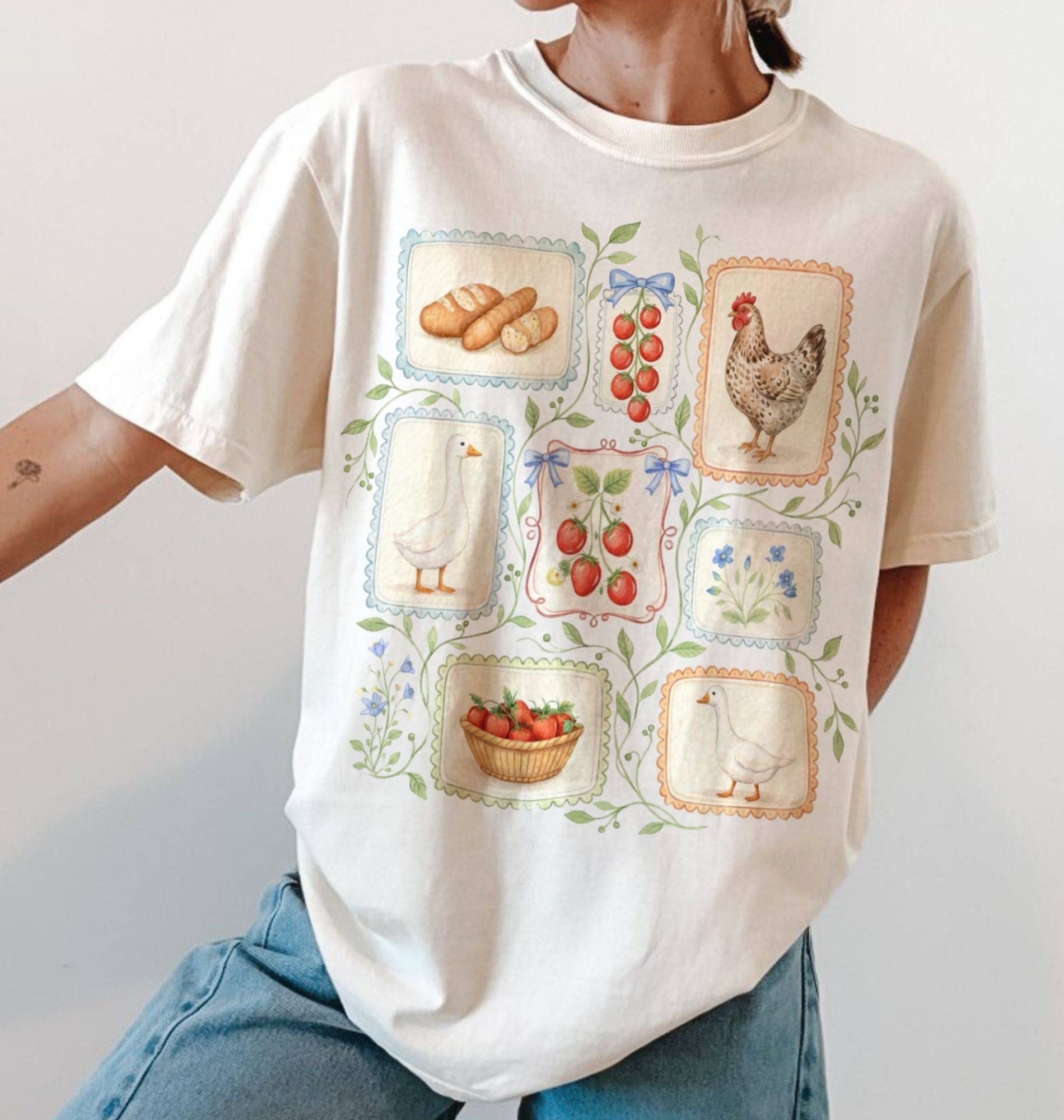 Person wearing a white t-shirt with farm-themed graphics on a plain background