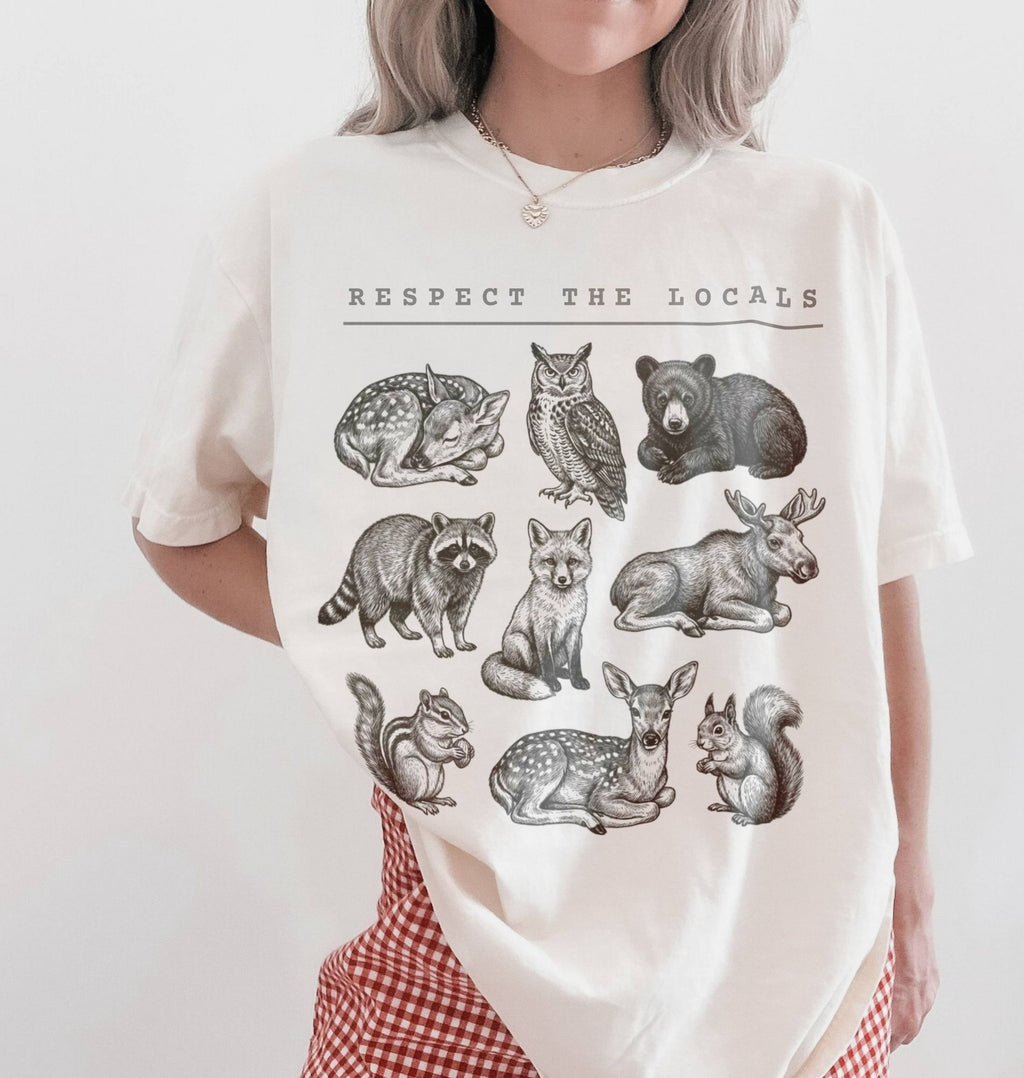 Respect the Locals forest animals shirt with vintage wildlife illustrations on a ivory t-shirt on a white background