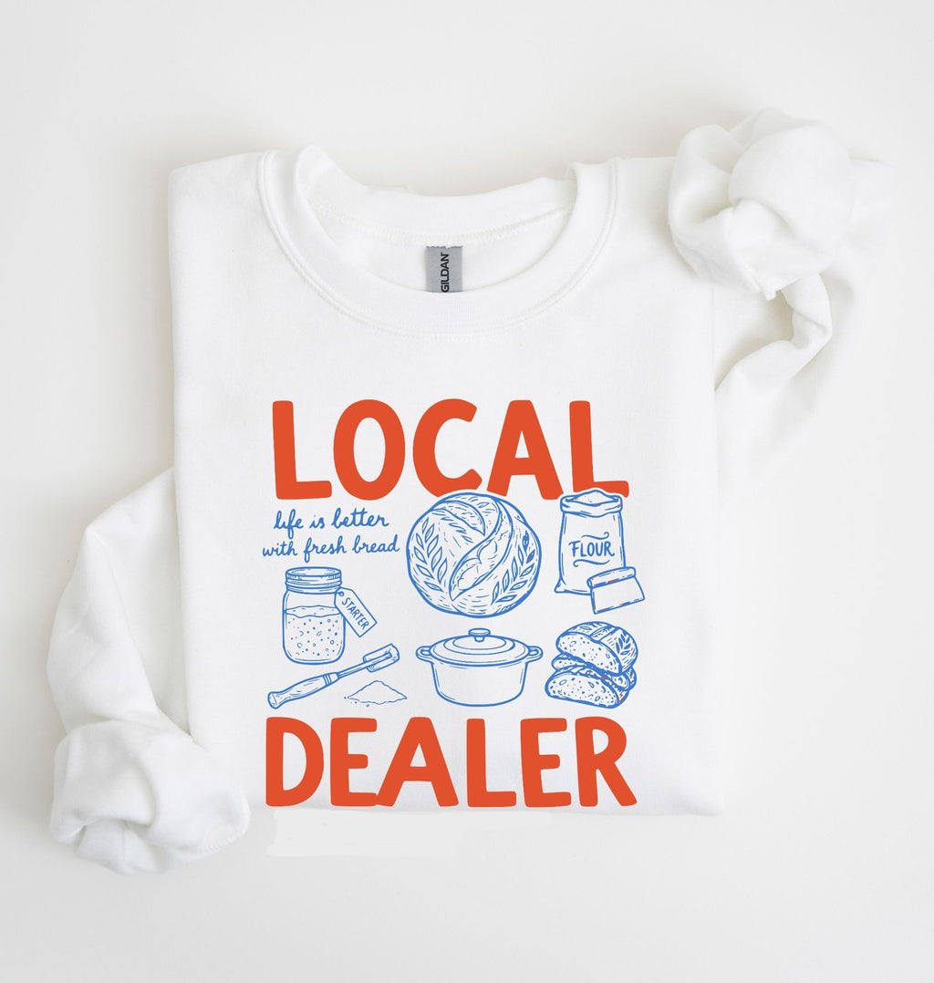 Flat lay of an white cottagecore baking sweatshirt with Local Dealer text and bread graphics gift for bakers on a white background 