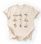 Flat lay of a Cute goose baking shirt with cottagecore bread baking illustrations on brown tee on a white background 