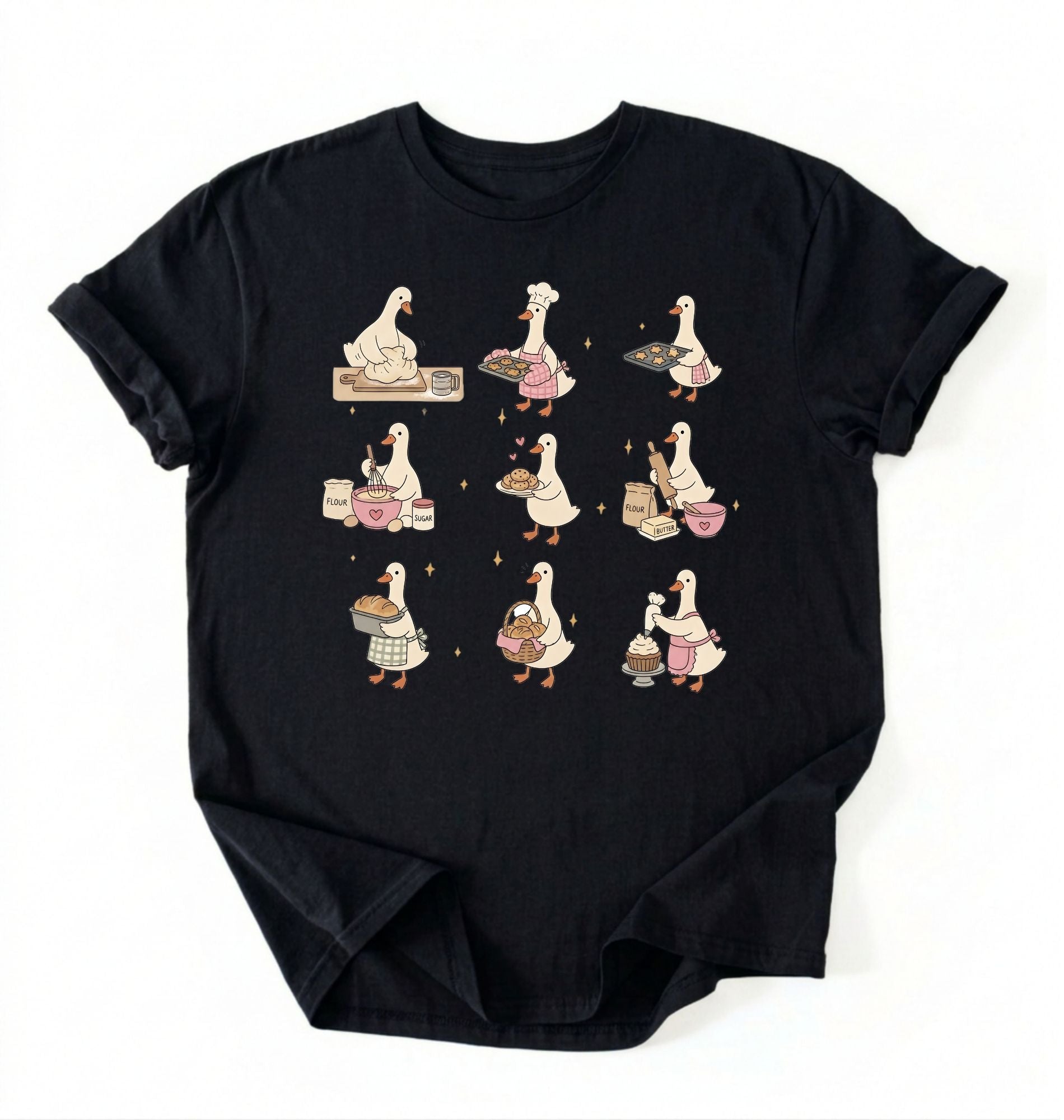 Flat lay of a Cute goose baking shirt with cottagecore bread baking illustrations on black tee on a white background 