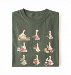 Flat lay of a Cute goose baking shirt with cottagecore bread baking illustrations on green tee on a white background 