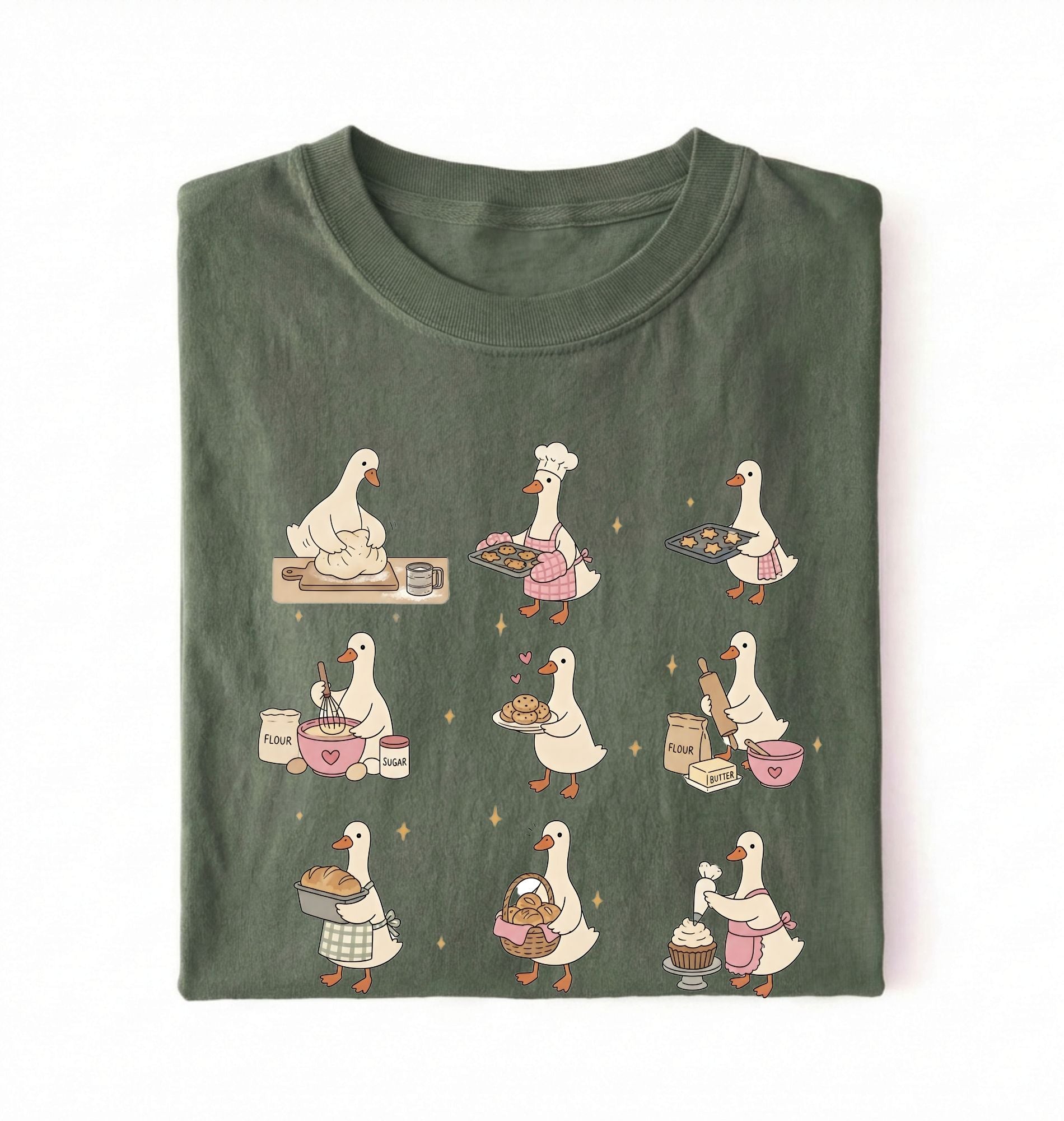 Flat lay of a Cute goose baking shirt with cottagecore bread baking illustrations on green tee on a white background 