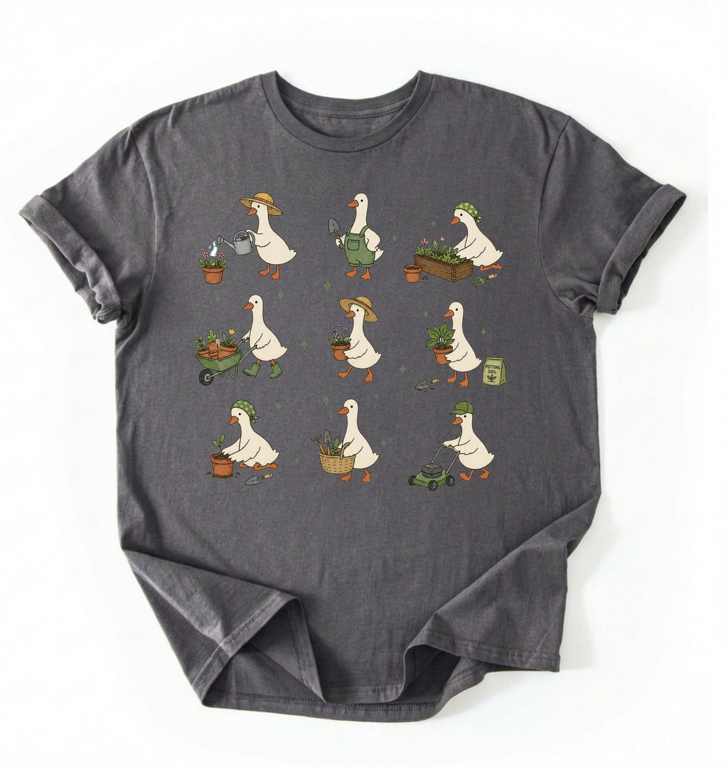 Flat lay of a gardening goose shirt a dark gray cute goose t shirt cottagecore gardening aesthetic gift on a white background 