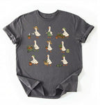 Flat lay of a gardening goose shirt a dark gray cute goose t shirt cottagecore gardening aesthetic gift on a white background 