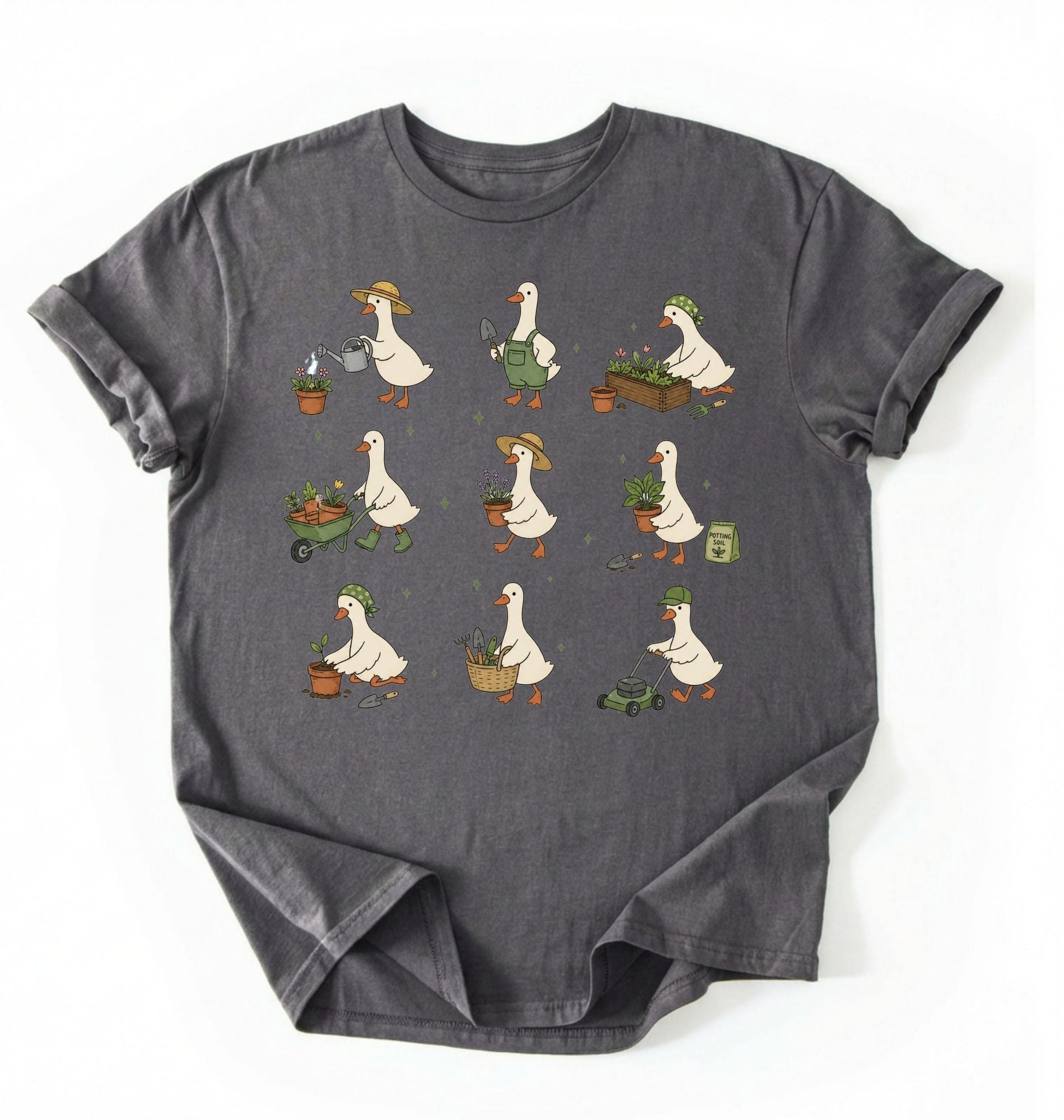 Flat lay of a gardening goose shirt a dark gray cute goose t shirt cottagecore gardening aesthetic gift on a white background 
