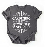 Flat lay of a charcoal Gardening is my favorite sport shirt with garden tools design perfect gift for gardeners and plant lovers on a white background