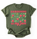 Flat lay of a green gardening is my jam shirt white funny plant lover t shirt cute strawberry garden gift on a white background 