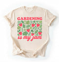 Flat lay of an ivory gardening is my jam shirt white funny plant lover t shirt cute strawberry garden gift on a white background 