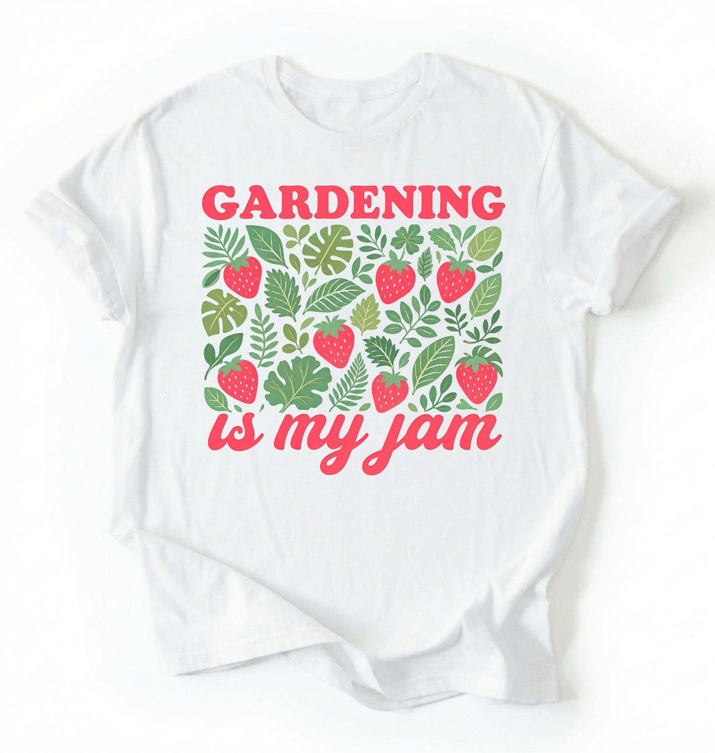Flat lay of a white gardening is my jam shirt white funny plant lover t shirt cute strawberry garden gift on a white background 