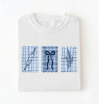 Flat lay of a white Cottagecore baking shirt with blue gingham pattern and baking icons perfect gift for bakers and vintage kitchen lovers on a white background 