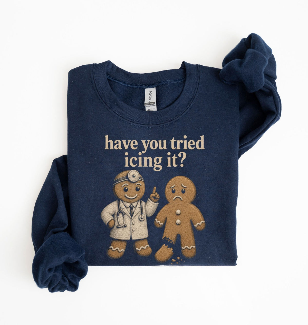 A navy blue long-sleeve sweatshirt with a graphic print of two gingerbread men and the text 'have you tried icing it?' in beige, laid flat on a white background.