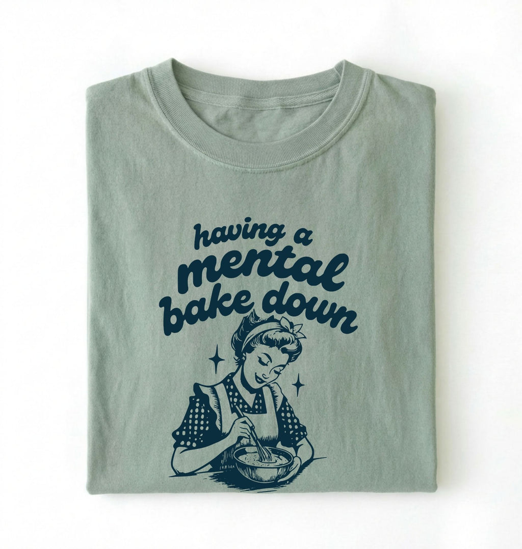 Flat lay of a bay having a mental bake down shirt with vintage baker illustration funny baking lover gift on a white background 