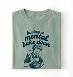 Flat lay of a bay having a mental bake down shirt with vintage baker illustration funny baking lover gift on a white background 