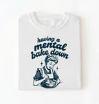 Flat lay of a white having a mental bake down shirt with vintage baker illustration funny baking lover gift on a white background 