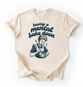 Flat lay of a cream having a mental bake down shirt with vintage baker illustration funny baking lover gift on a white background 