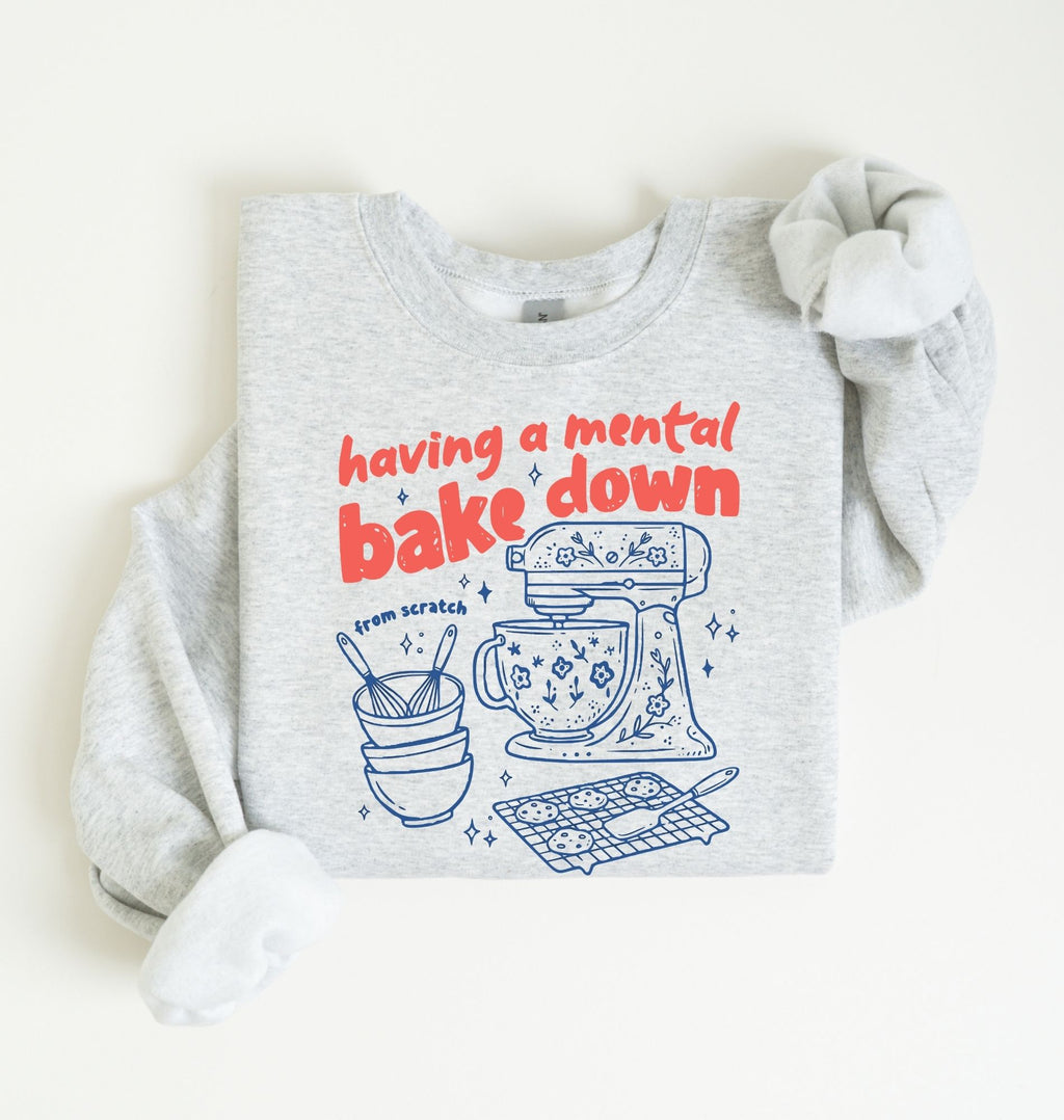 Flat lay of a ash Funny Having a Mental Bake Down baking sweatshirt with mixer and baking tools graphic on a white background 
