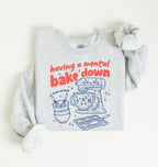 Flat lay of a ash Funny Having a Mental Bake Down baking sweatshirt with mixer and baking tools graphic on a white background 