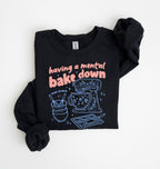 Flat lay of a black Funny Having a Mental Bake Down baking sweatshirt with mixer and baking tools graphic on a white background 