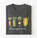Flat lay of a pepper homegrown vegetable t shirt with illustrated carrot celery turnip and corn gardener gift on a white background