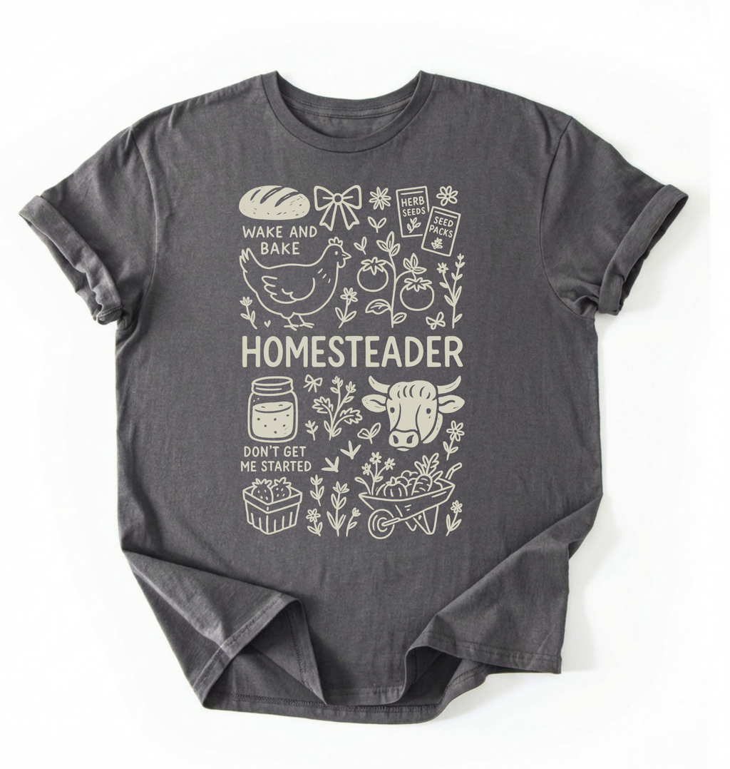 Flat lay of a charcoal homesteader shirt with chicken farm garden and baking icons cottagecore aesthetic gift white t-shirt on a white backgroud