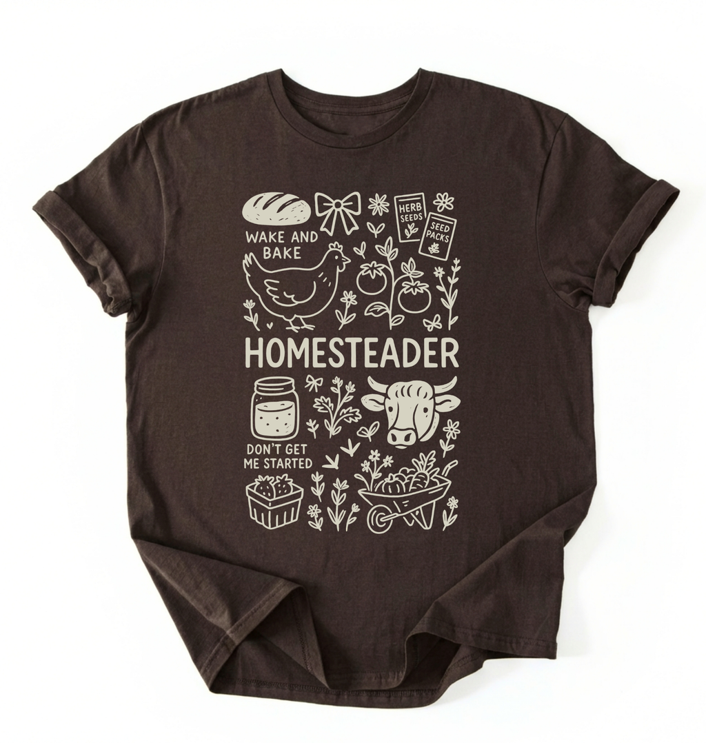 Flat lay of a dark chocolate homesteader shirt with chicken farm garden and baking icons cottagecore aesthetic gift white t-shirt on a white backgroud