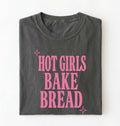 Flat lay of a pepper hot girls bake bread shirt with pink text funny sourdough baker gift black t-shirt on a white background 