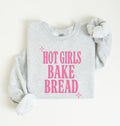Flat lay of an ash Hot Girls Bake Bread graphic sweatshirt for sourdough lovers and home bread bakers on a white background 