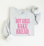 Flat lay of an ash Hot Girls Bake Bread graphic sweatshirt for sourdough lovers and home bread bakers on a white background 