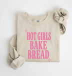 Flat lay of an sand Hot Girls Bake Bread graphic sweatshirt for sourdough lovers and home bread bakers on a white background 