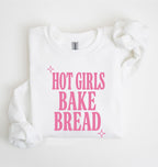 Flat lay of an white Hot Girls Bake Bread graphic sweatshirt for sourdough lovers and home bread bakers on a white background 