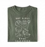 Flat lay of a Funny hot girls bake sourdough shirt with bread and baking tools illustration on green tee on a white background 