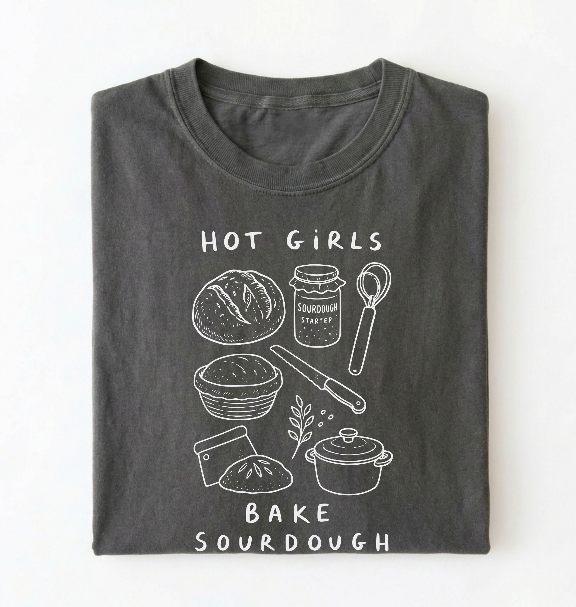 Flat lay of a Funny hot girls bake sourdough shirt with bread and baking tools illustration on pepper tee on a white background 