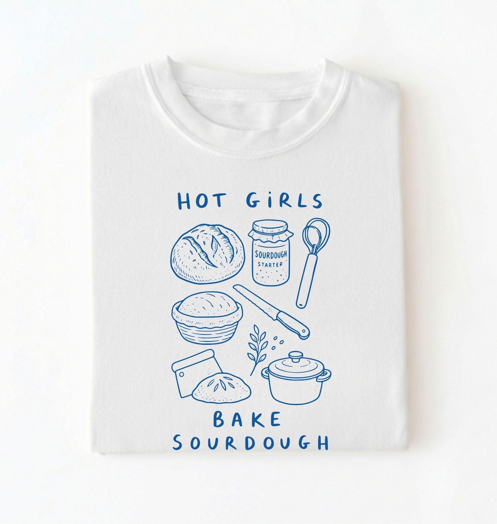 Flat lay of a Funny hot girls bake sourdough shirt with bread and baking tools illustration on white tee on a white background 