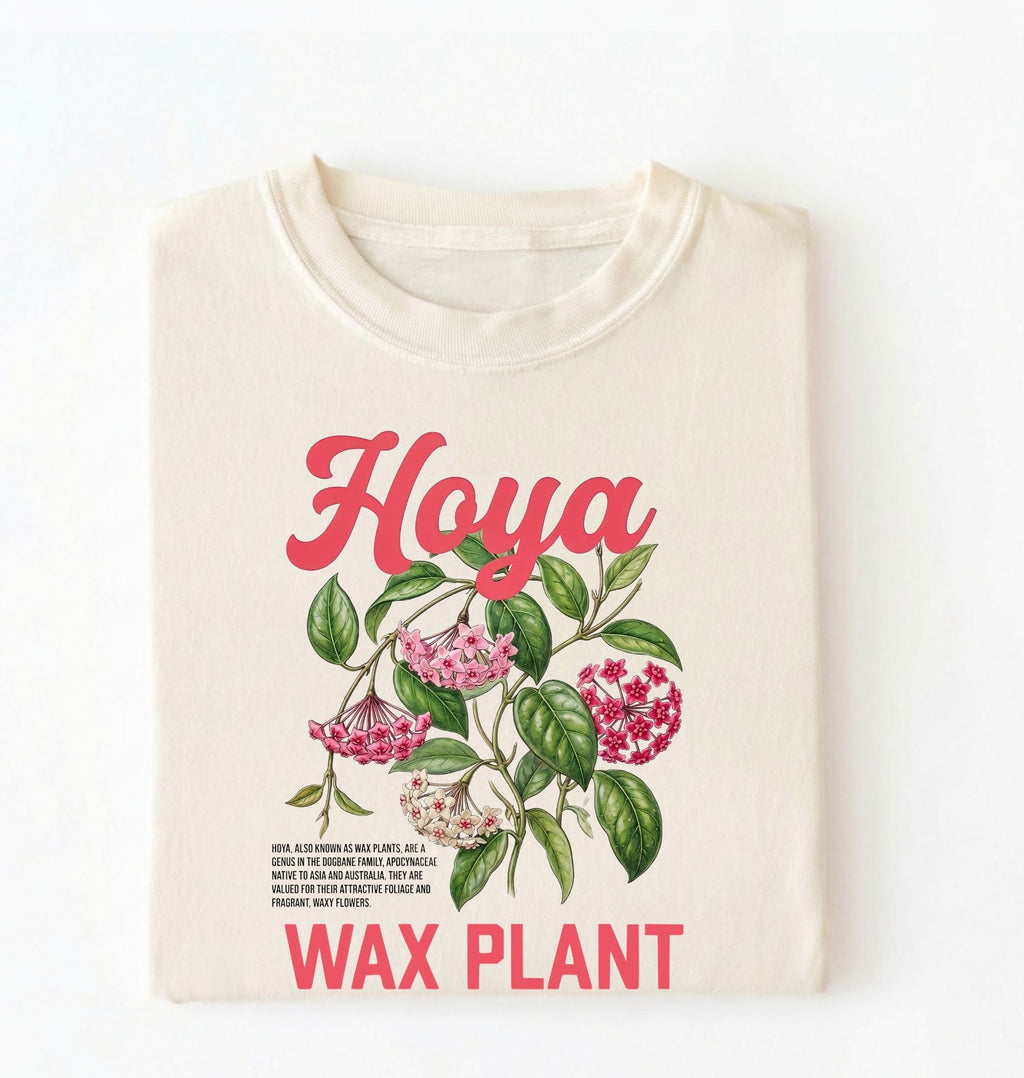 Flat lay of a ivory t-shirt featuring a detailed botanical illustration labeled “Hoya Wax Plant” with flowers and leaves.