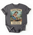 Flat lay of a charcoal Funny I bury things gardening shirt with vintage illustration perfect gift for gardeners and plant lovers with humor on a white background