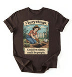 Flat lay of a dark chocolate Funny I bury things gardening shirt with vintage illustration perfect gift for gardeners and plant lovers with humor on a white background 