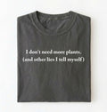 Flat lay of a pepper cozy crewneck t-shirt on a white background with a white text displaying the phrase “I don’t need more plants (and other lies I tell myself)” centered on the front