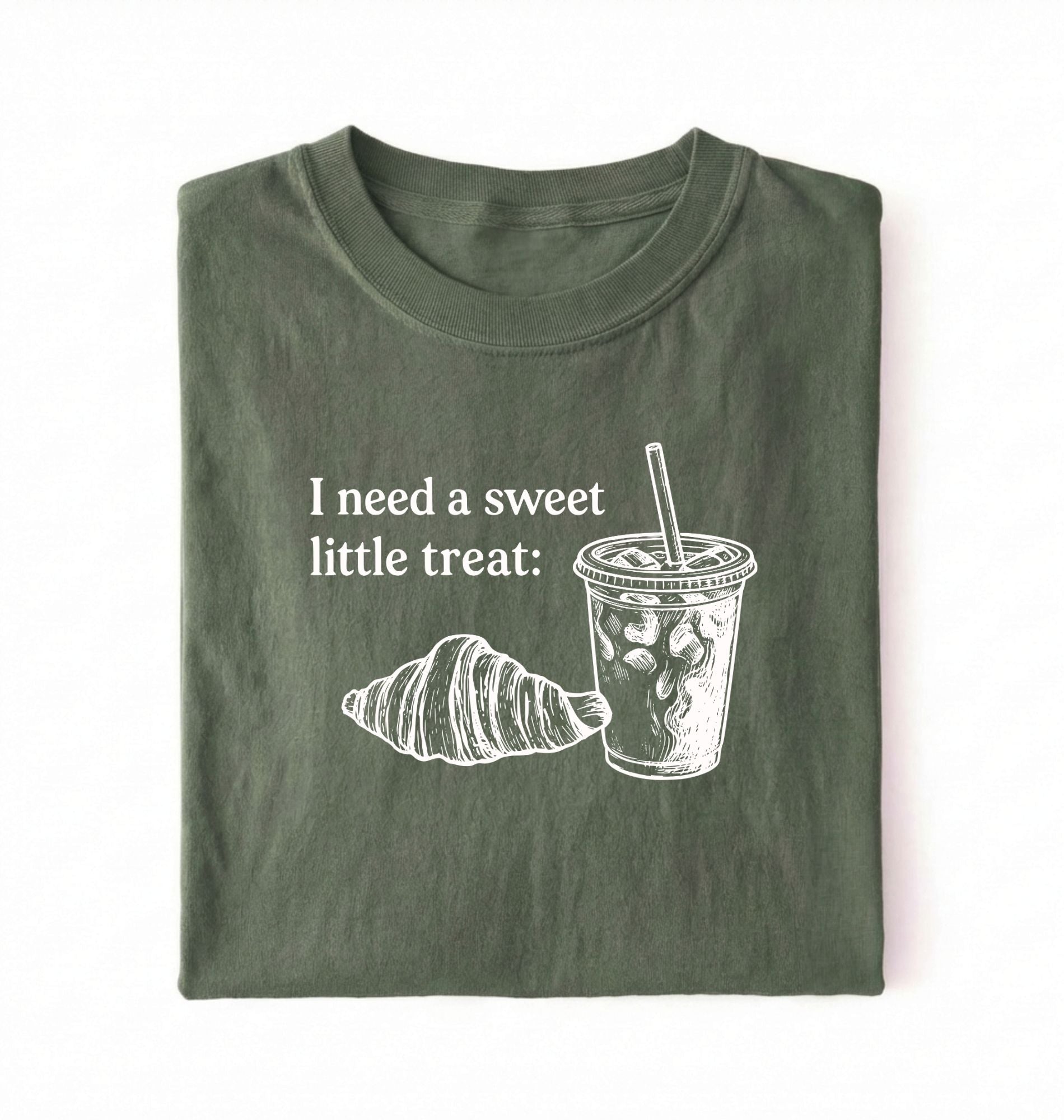 Flat lay of a Cute coffee and croissant shirt with cozy bakery aesthetic on black tee on a green background 
