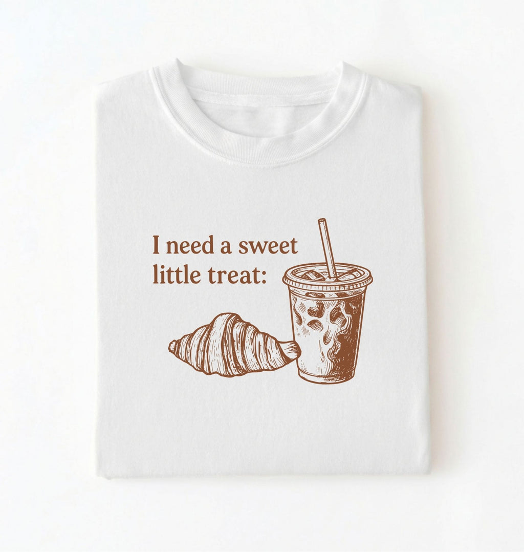 Flat lay of a Cute coffee and croissant shirt with cozy bakery aesthetic on white tee on a white background 
