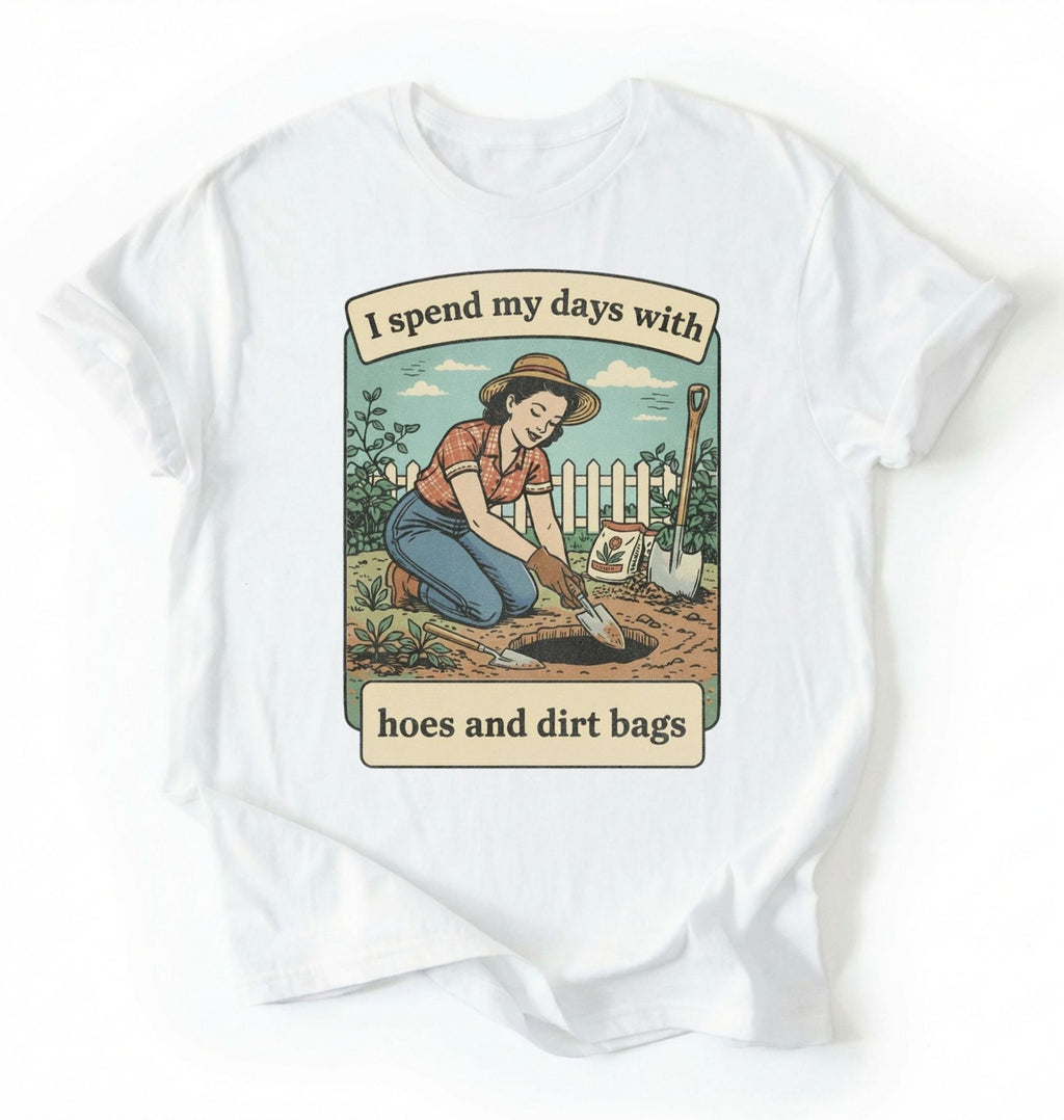 Flat lay of a white Funny gardening shirt with hoes and dirt bags text perfect for gardeners and plant lovers with humor on a white background 
