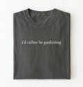 Flat lay of a pepper shirt written I’d rather be gardening t-shirt with minimalist text design, perfect gardener and plant lover gift on a white background