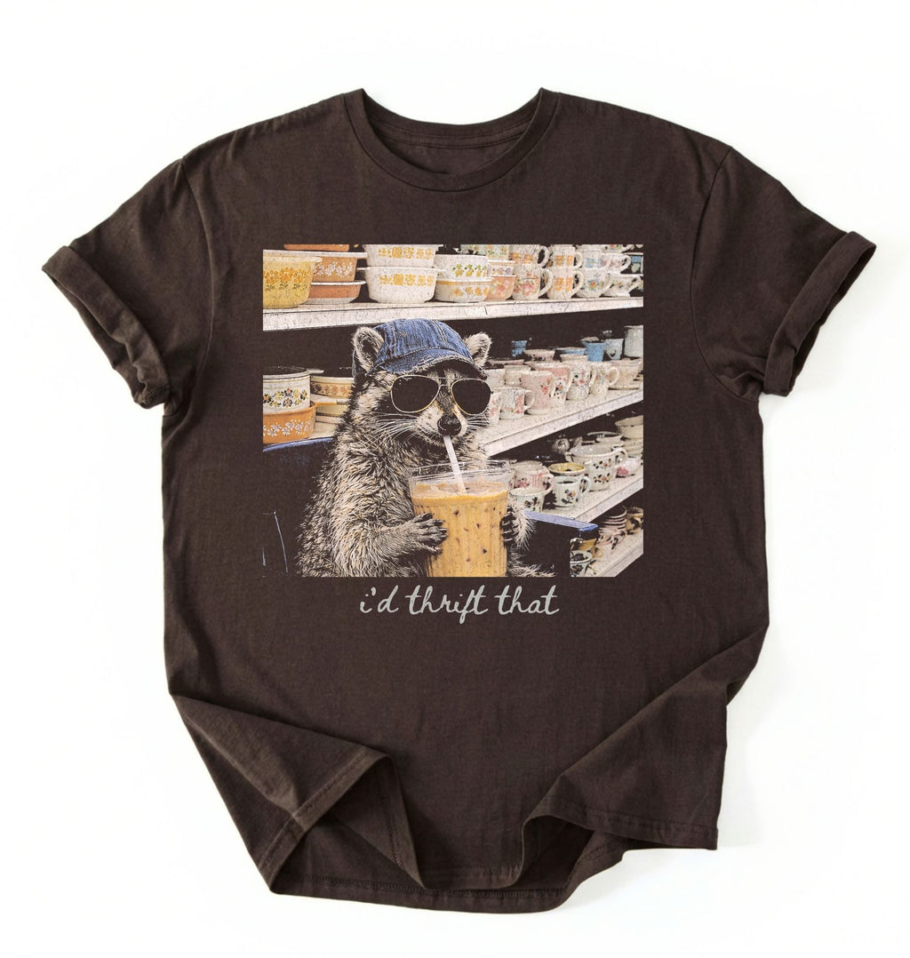 Flat lay of a id thrift that raccoon shirt dark chocolate funny thrift shopping t shirt vintage lover gift on a white background 
