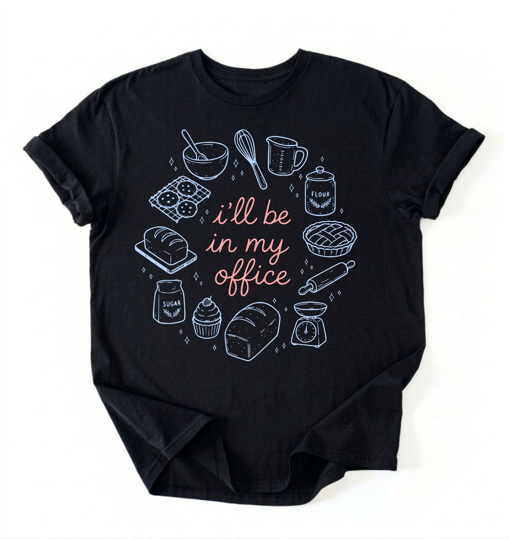 Flat lay of a Funny baking shirt with bread pie cupcake and baking tools illustration on black tee on a white background 