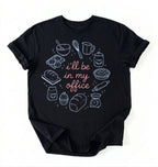 Flat lay of a Funny baking shirt with bread pie cupcake and baking tools illustration on black tee on a white background 