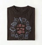 Flat lay of a Funny baking shirt with bread pie cupcake and baking tools illustration on darkchocolate tee on a white background 
