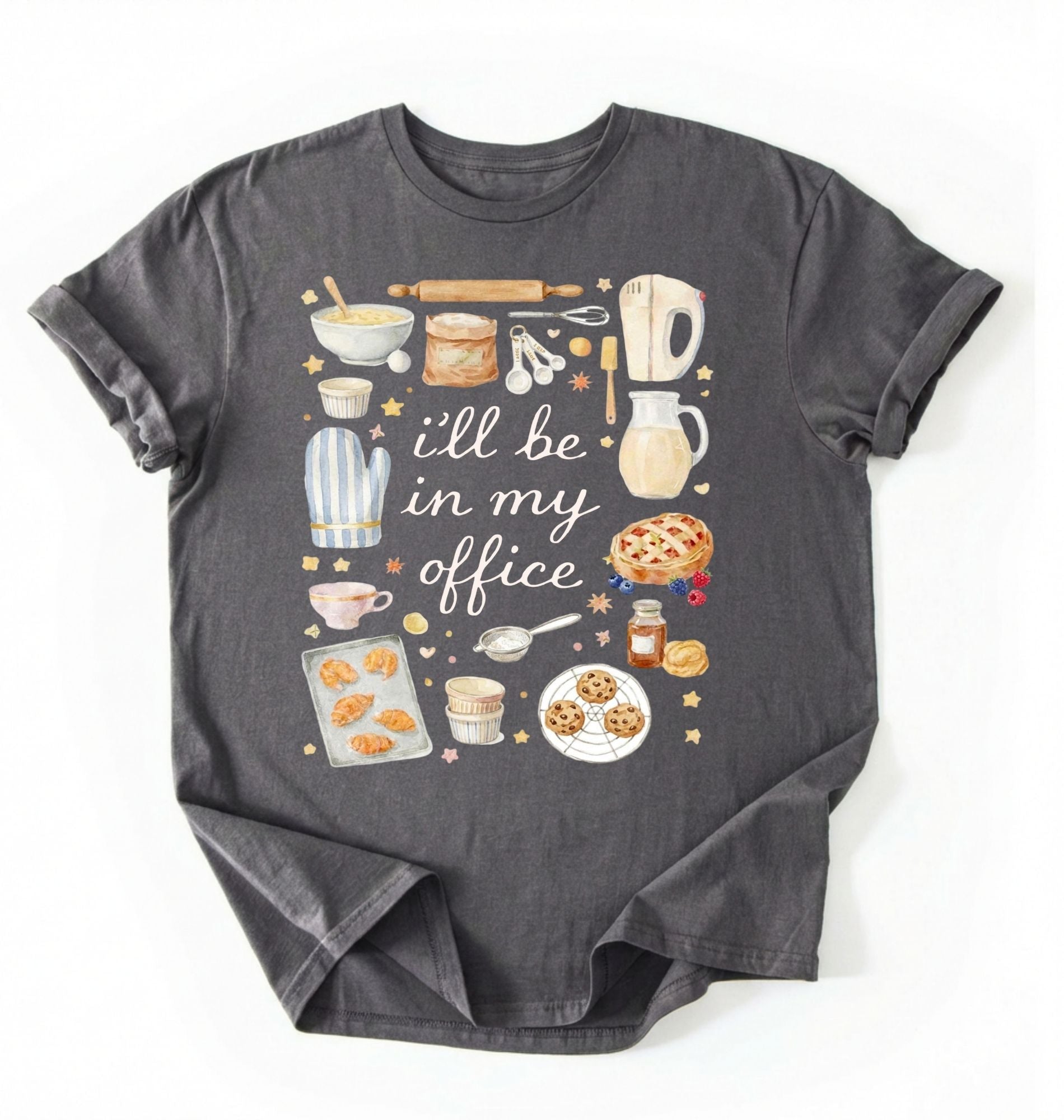 Flat lay of a charcoal Baking shirt with tools and desserts saying ill be in my office perfect gift for bakers and home baking lovers on a white background